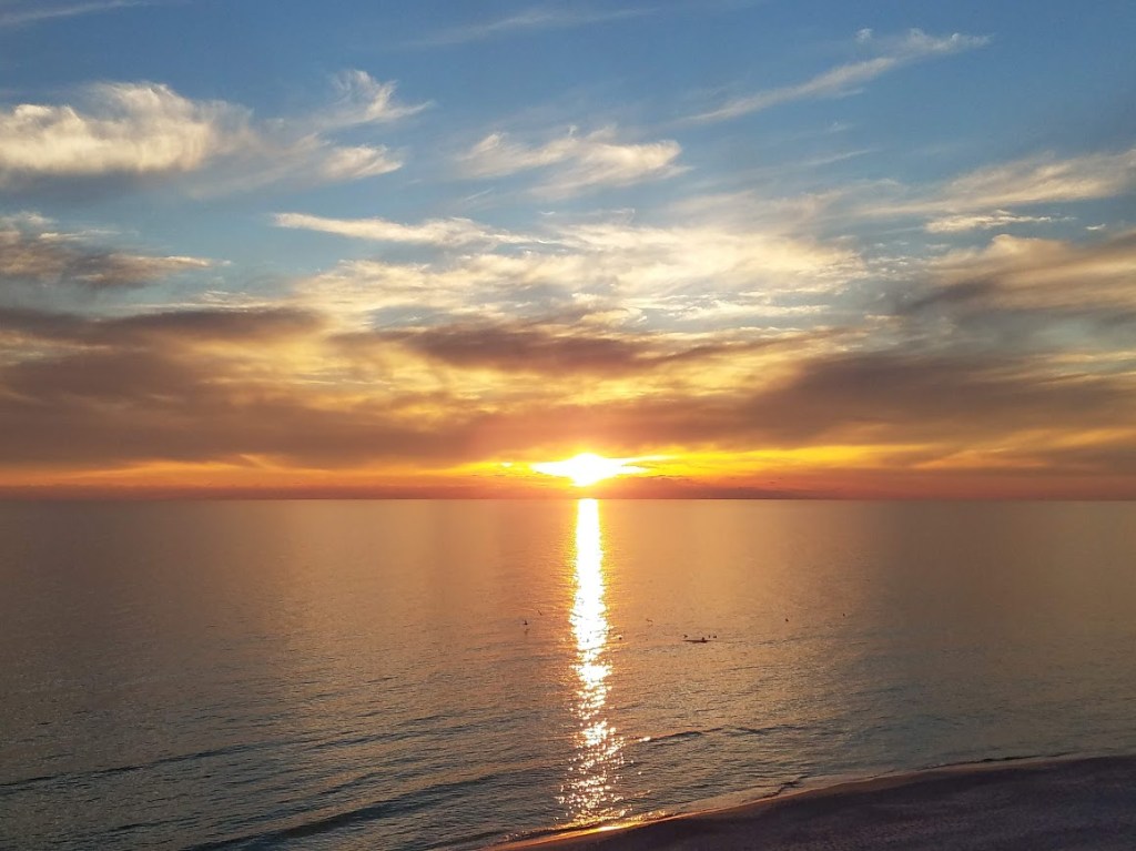 Golden sunset reflecting across the calm Gulf waters at Panama City Beach